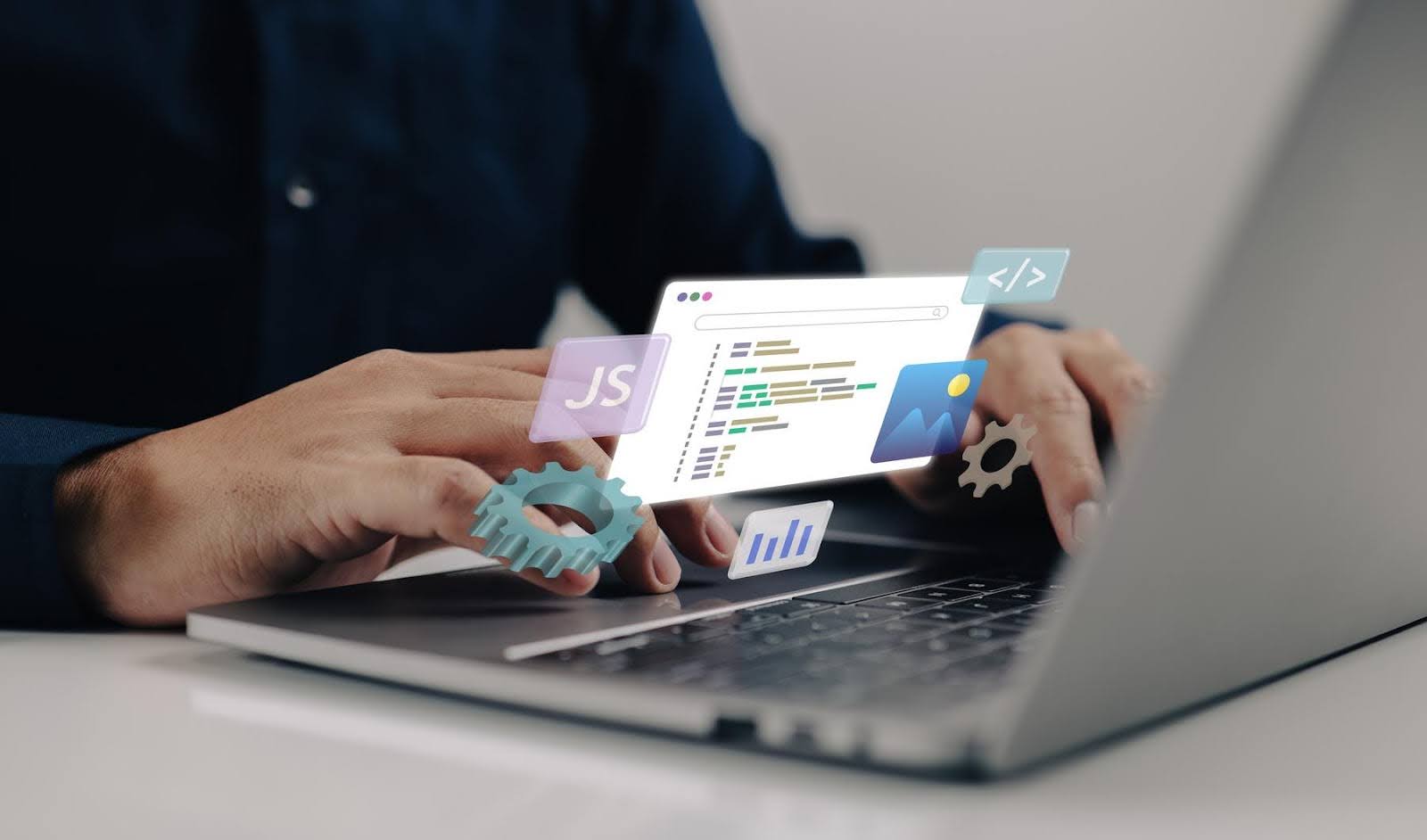 Person typing on a laptop with floating digital icons for coding, JavaScript, images, charts, and gears, representing website development and maintenance tasks essential for small businesses.