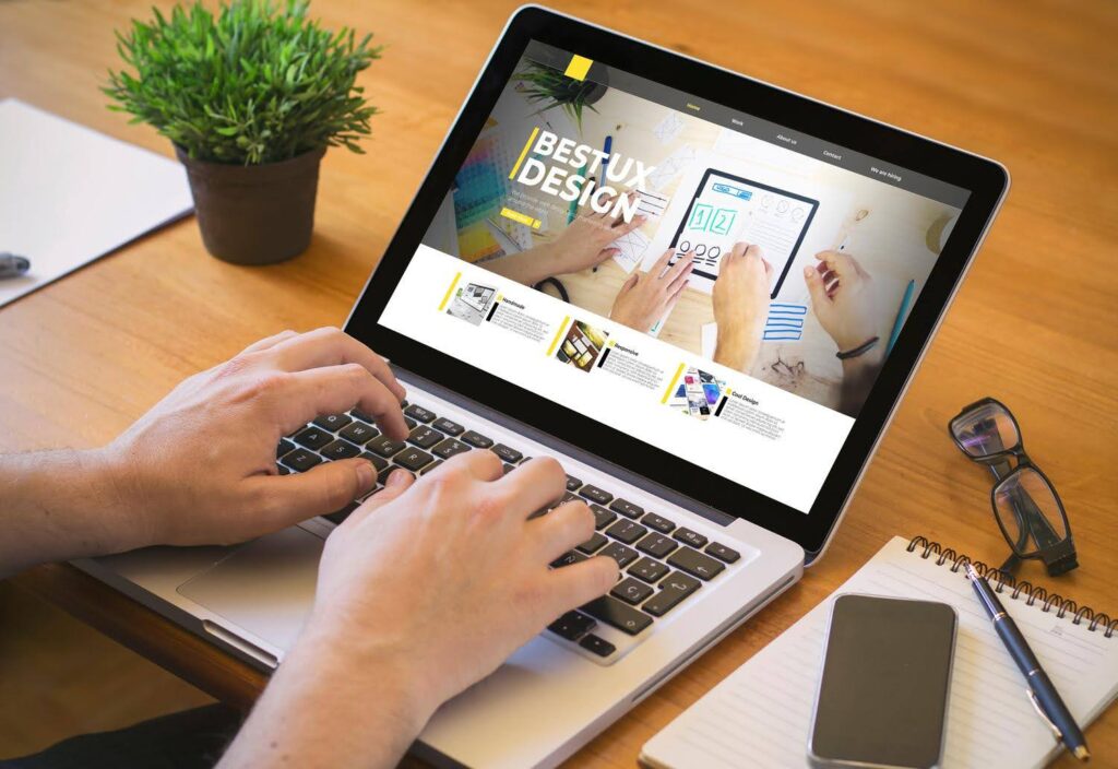 Person working on a laptop displaying a website design layout, symbolizing how poor web design or user experience can silently scare away potential investors.