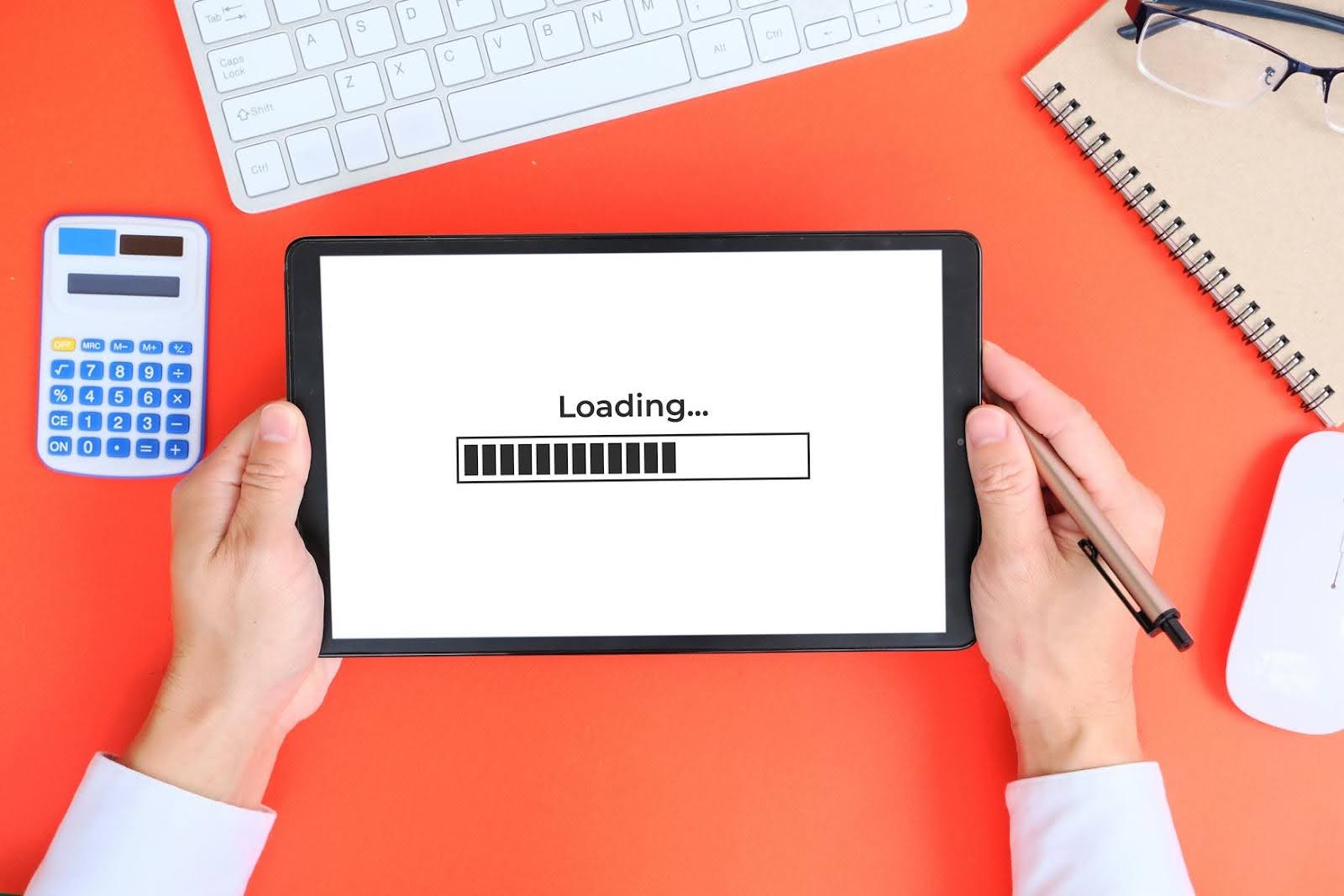 Digital marketing test concept showing a tablet loading screen during a website performance check for speed and user experience.