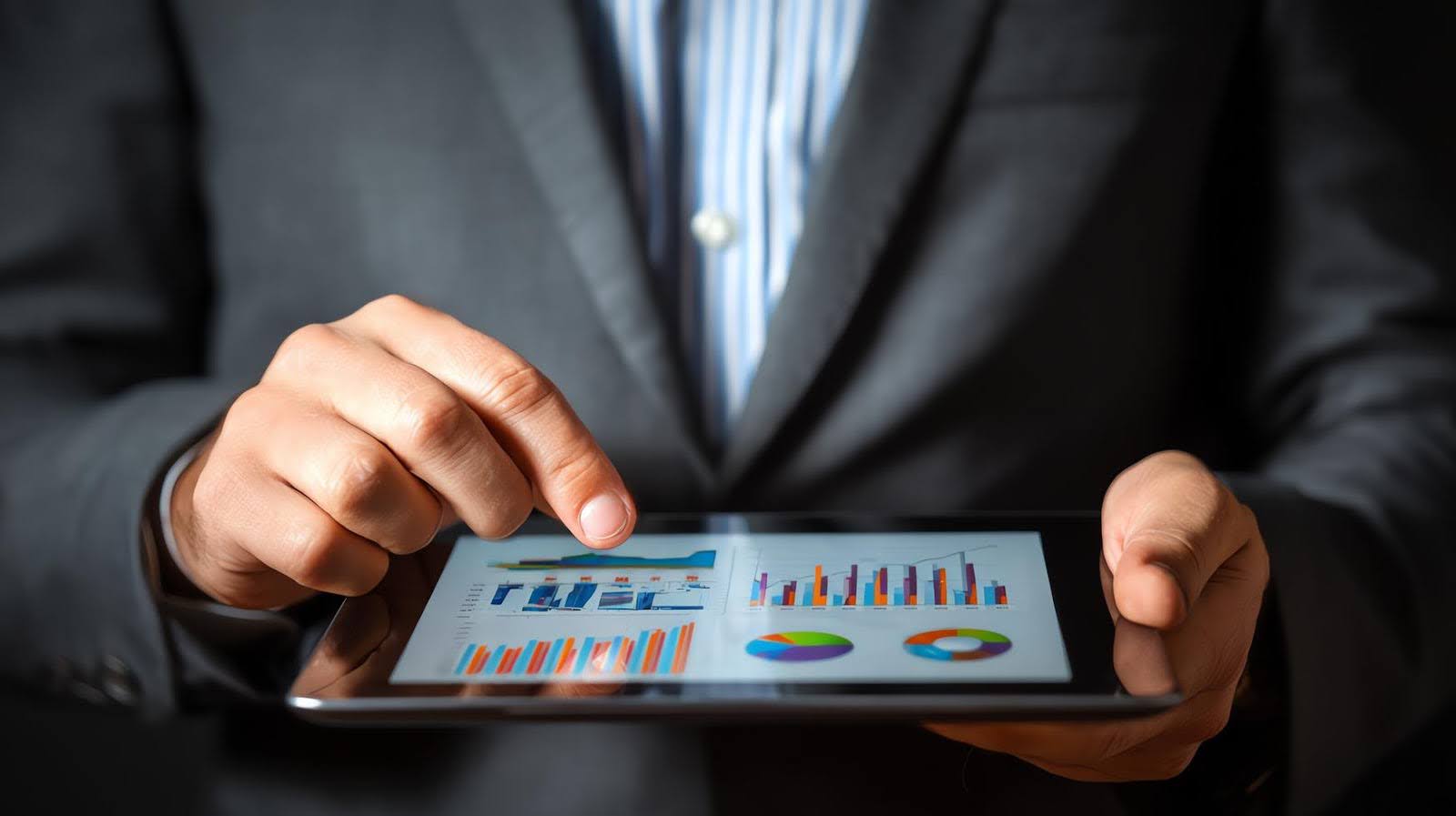 Tech Fellow digital marketing expert reviewing performance metrics on a tablet screen with charts and graphs to analyze accurate data trends.