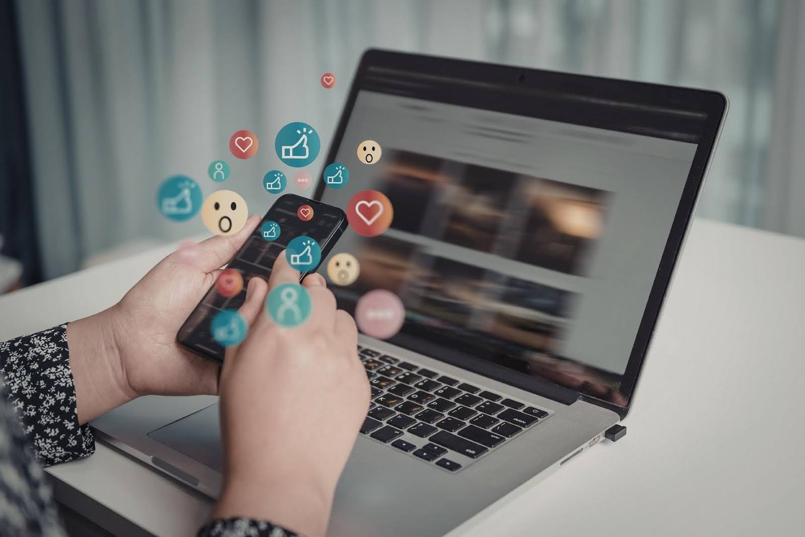 Techfellow analyzing Posting strategy on social media, shown by a smartphone and laptop with engagement icons, highlighting how strategic posting turns content into measurable business profit.