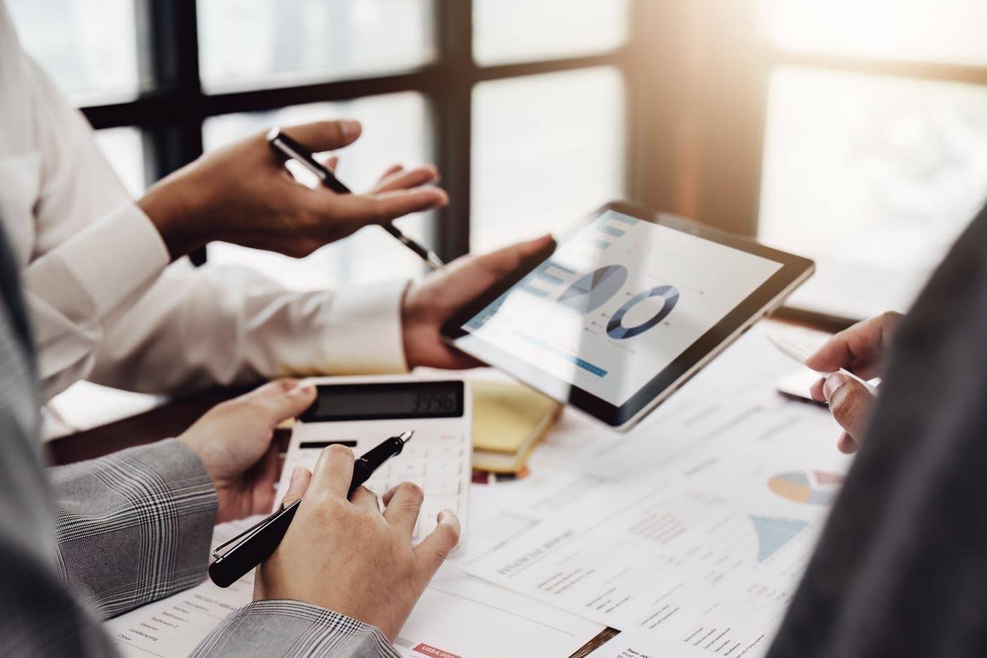 Business team reviewing sales data and financial reports as rapid sales growth puts pressure on back-office operations at Techfellow.