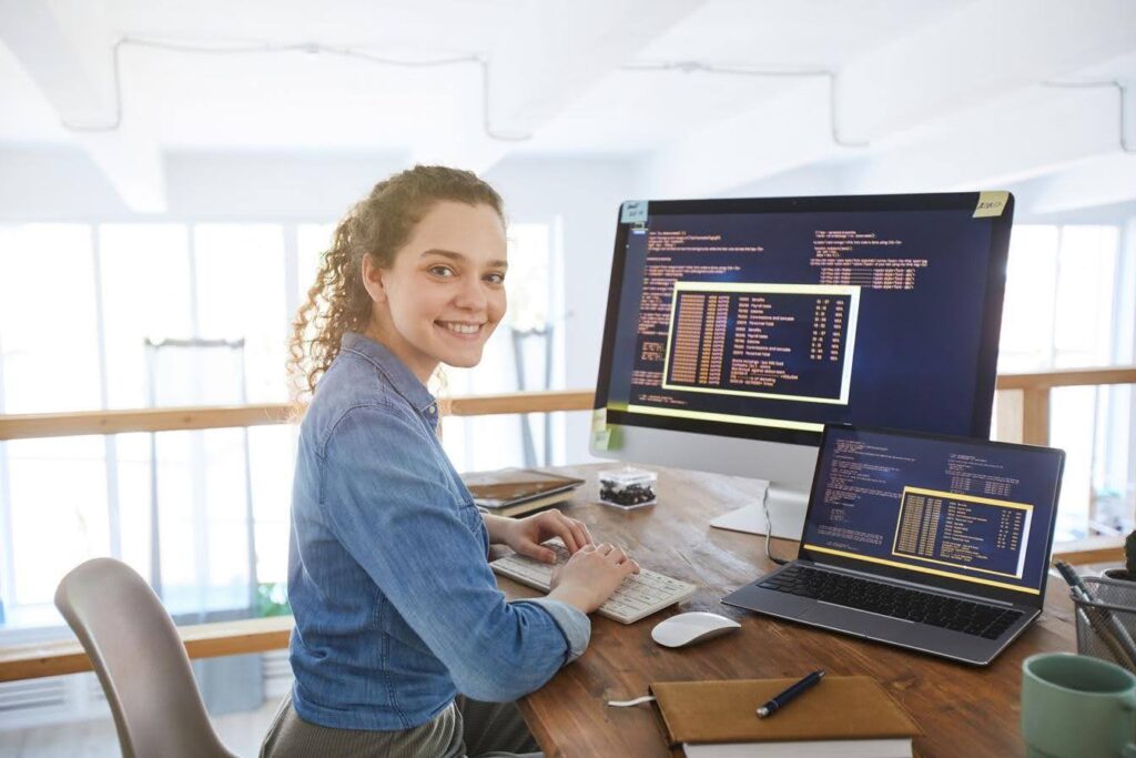 Web developer reviewing a service page on multiple screens to improve customer experience and conversions for Techfellow.