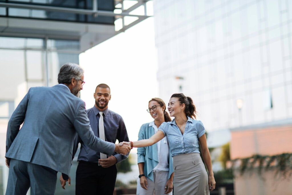 Business professionals managing rapid sales growth while a virtual assistant supports expanding back-office operations with Techfellow.