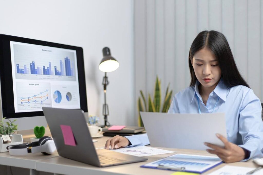 Business professional reviewing website performance reports and analytics to determine whether a website redesign or improved digital marketing strategy is needed.