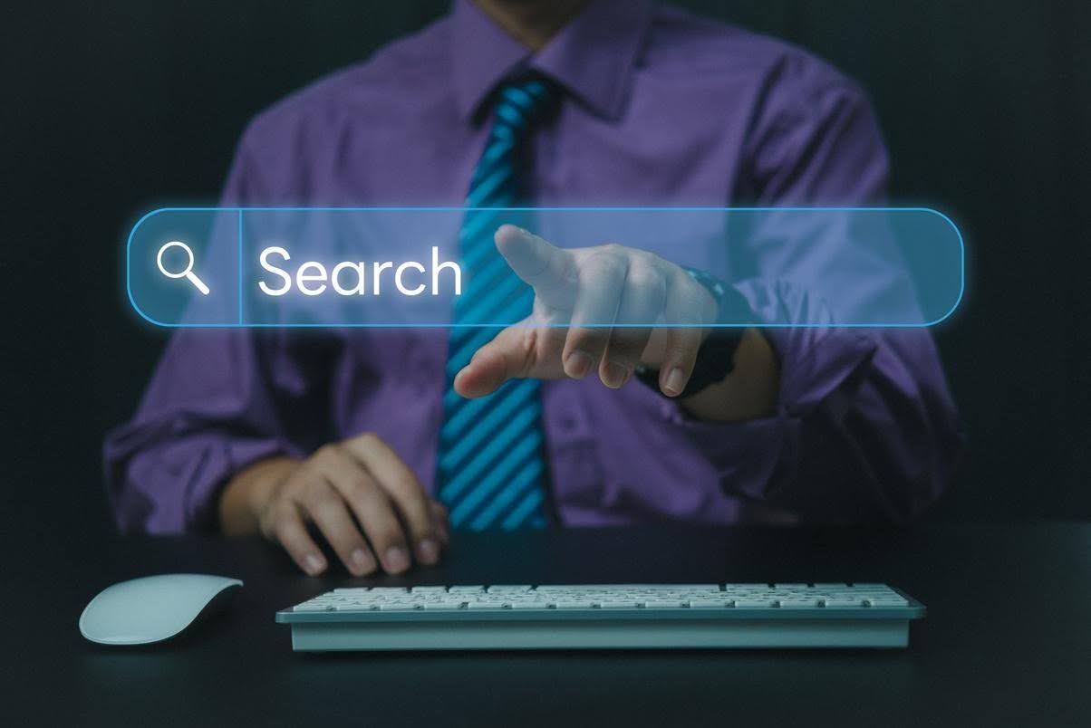 Business professional interacting with a digital search bar, illustrating how SEO strategies and search intent influence website visibility and relevant traffic.