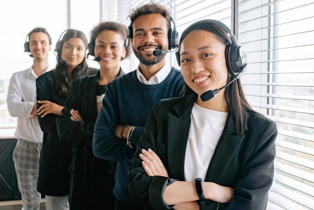 Business customer support team wearing headsets, ready to manage increasing customer inquiries and improve response times through organized communication